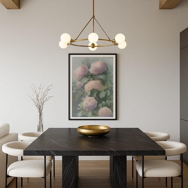 Dining room with a black marble table, gold bowl, and floral painting on the wall.