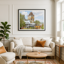 Living room with a beige sofa, armchair, and coffee table with a glass of water. A framed picture of Chateau Frontenac, Quebec, is on the wall.