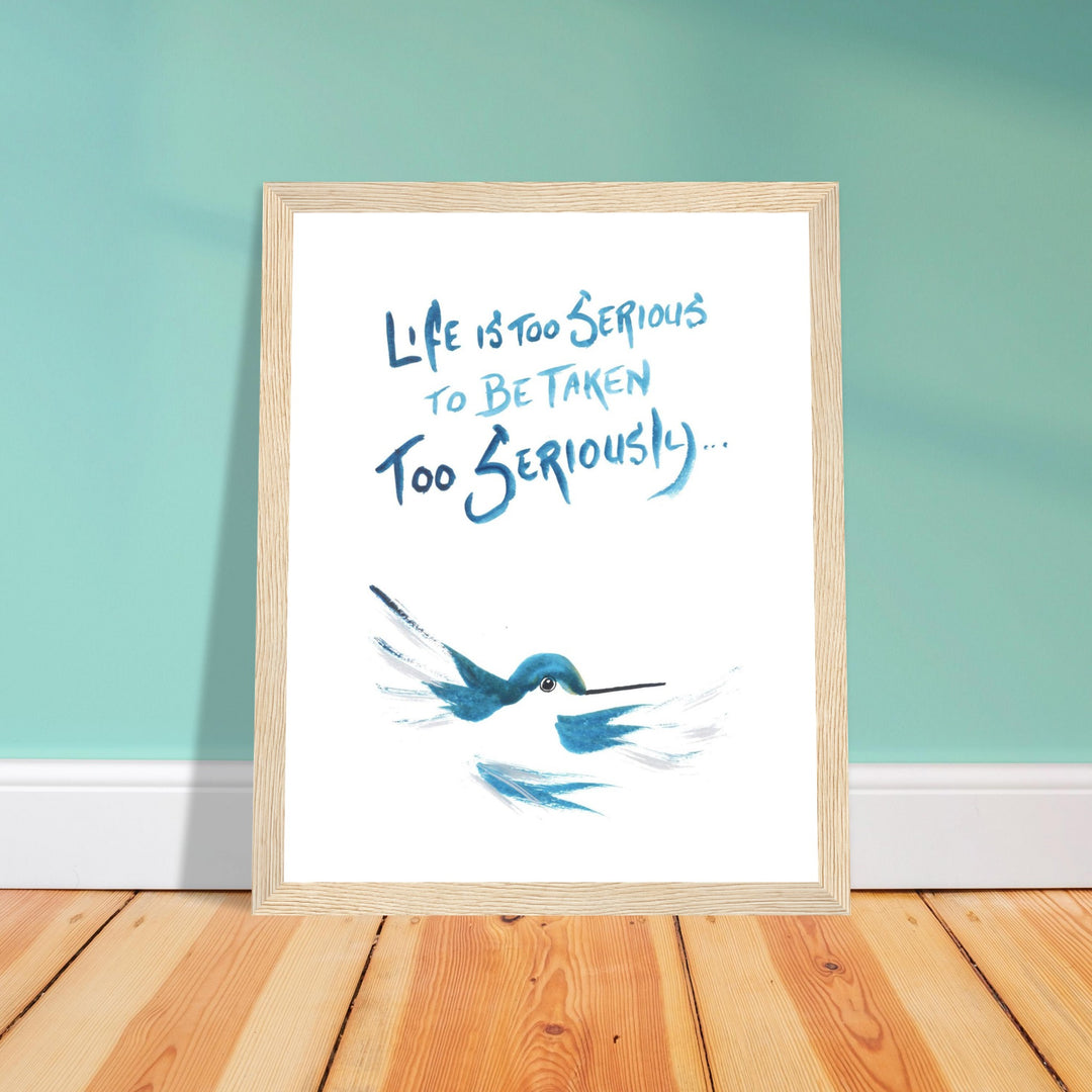 Artwork of a hummingbird with inspirational quote in a wood frame against a turquoise wall.