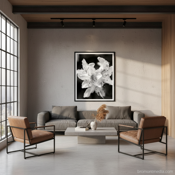 Modern office lobby with gray sofa, brown chairs, and a floral artwork on the wall - by Andrew Semple on Bromont Media