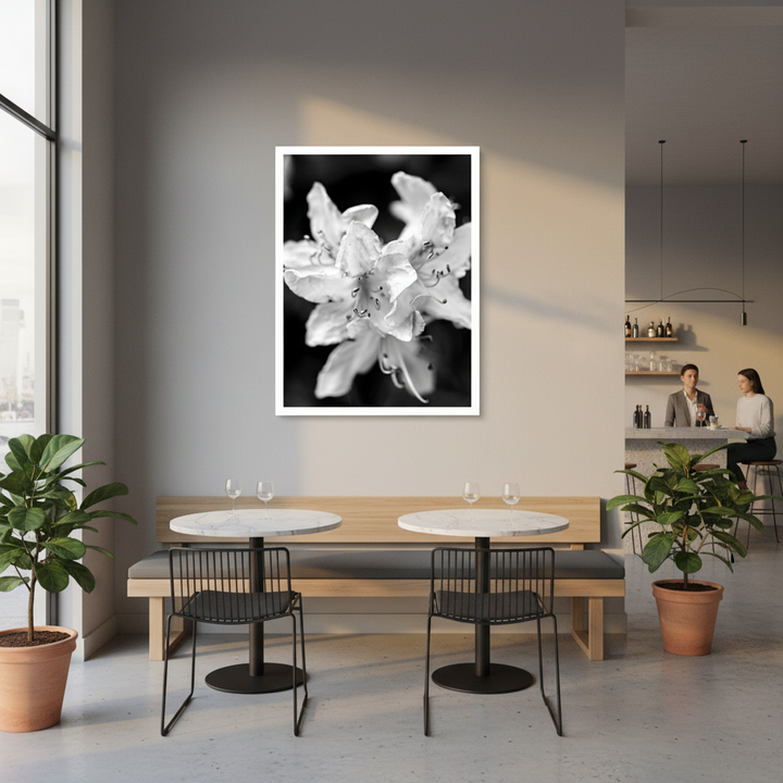 Modern dining area in restaurant with a black and white floral artwork on the wall - by Andrew Semple on Bromont Media