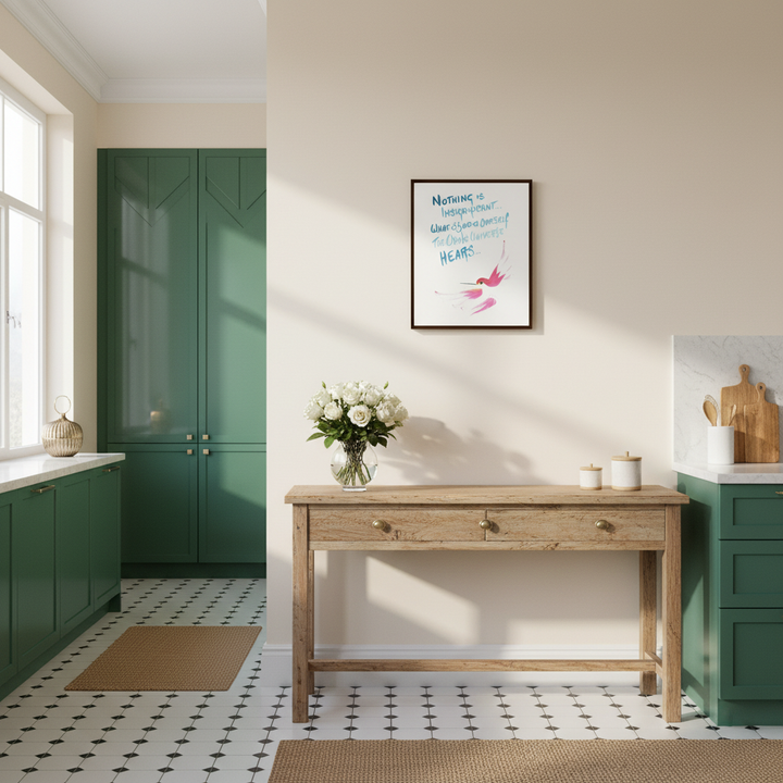 Kitchen with a wooden console table, green cabinets, and framed hummingbird artwork on the wall - by Andrew Semple on Bromont Media