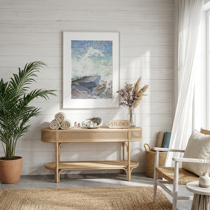 Nautical-themed room with a wicker console table, plant, and framed artwork from Bromont Media
