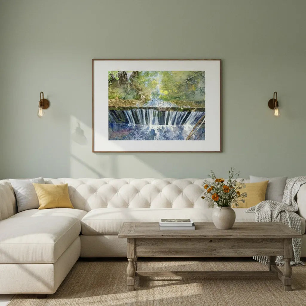 Living room with a white sofa, wooden coffee table, and framed artwork on the wall - Studio Shefford
