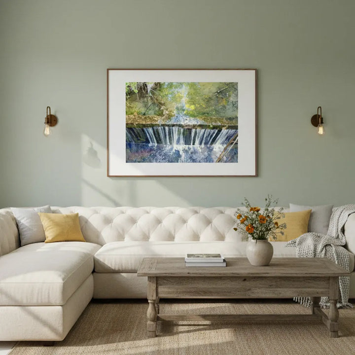Living room with a white sofa, wooden coffee table, and framed artwork on the wall - Studio Shefford
