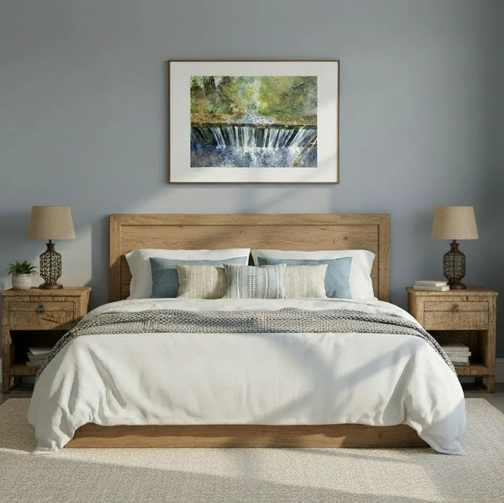 Bedroom with wooden headboard, white bedding, and framed artwork on gray wall.
