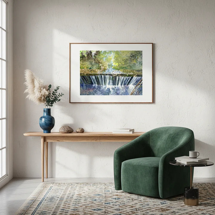Modern living room with a green armchair, wooden table, and framed artwork of a waterfall - Studio Shefford