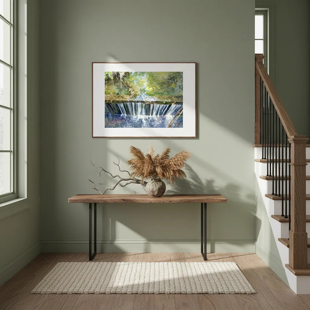 Framed artwork of a waterfall on a wall above a wooden bench with decorative elements - Studio Shefford