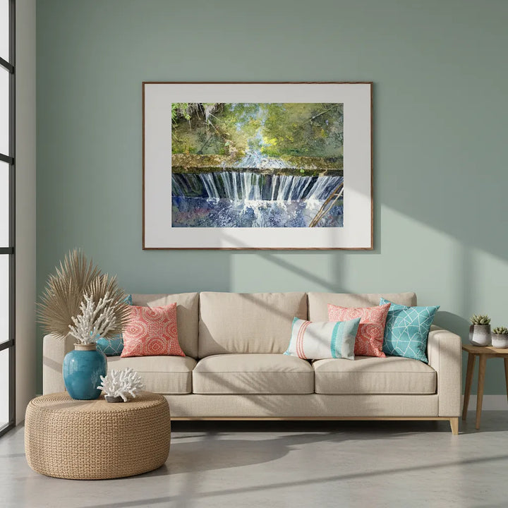 Living room with beige sofa, colorful pillows, and a framed picture of a waterfall on the wall - Studio Shefford