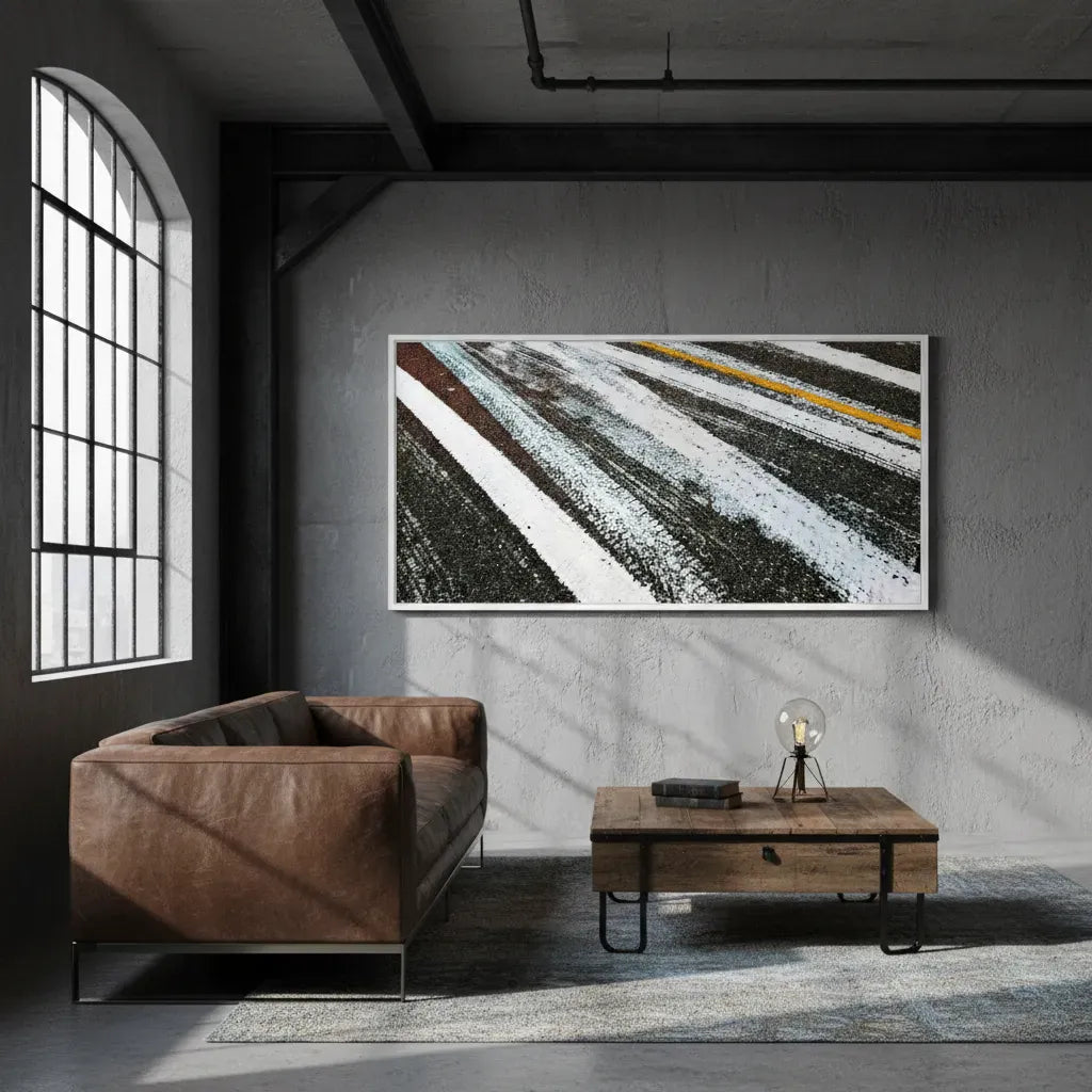Modern living room with a brown leather sofa, wooden coffee table, and abstract art on the wall - Studio Shefford