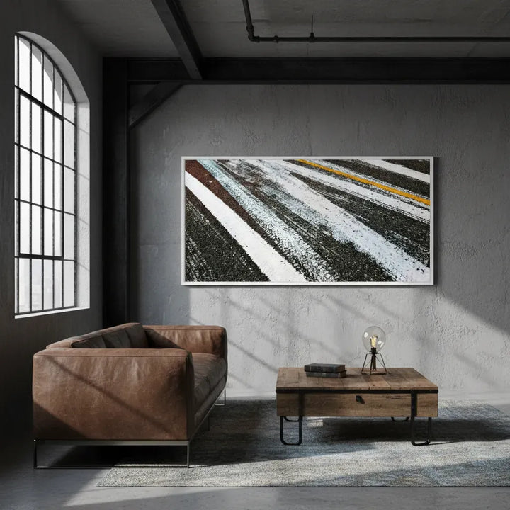 Modern living room with a brown leather sofa, wooden coffee table, and abstract art on the wall - Studio Shefford