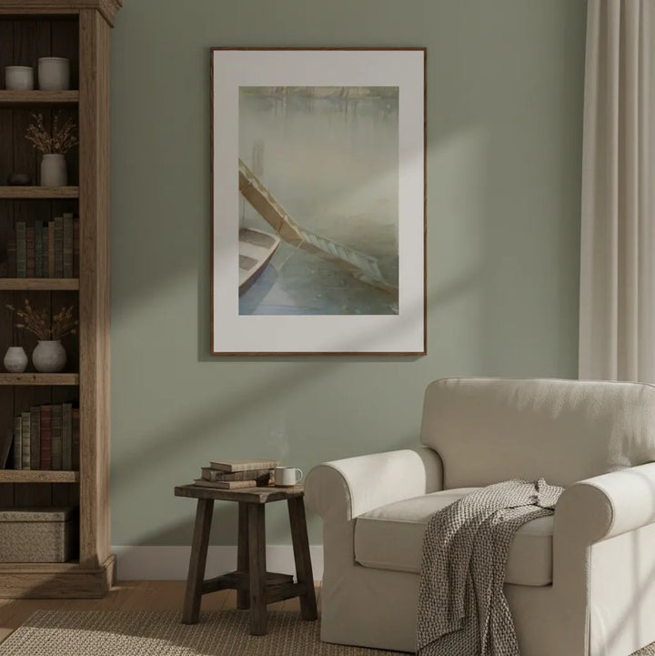 Living room with a beige armchair, wooden side table, and framed artwork on a green wall - Bromont Media