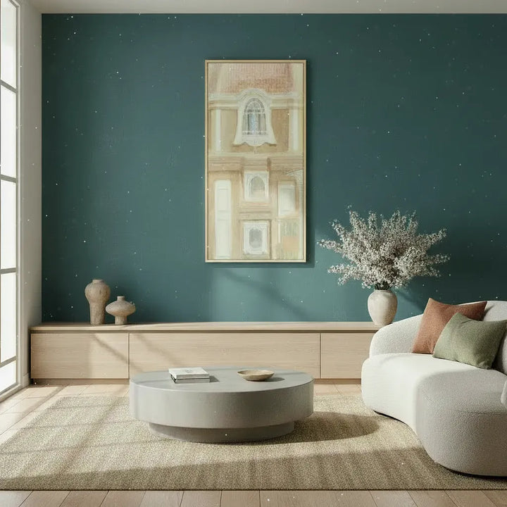 Modern living room with teal walls, a white sofa, and wall art of italian architecture