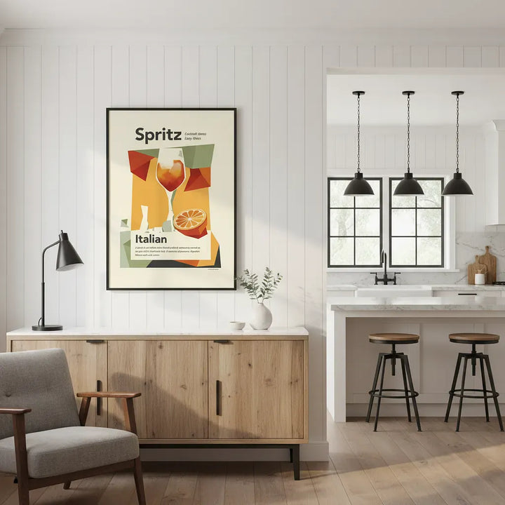 Modern kitchen with wooden cabinet, gray chair, and framed Spritz poster.