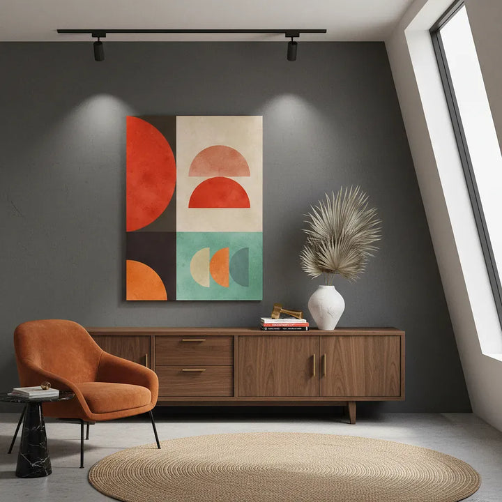 Modern living room with abstract art, wooden cabinet, and orange chair.
