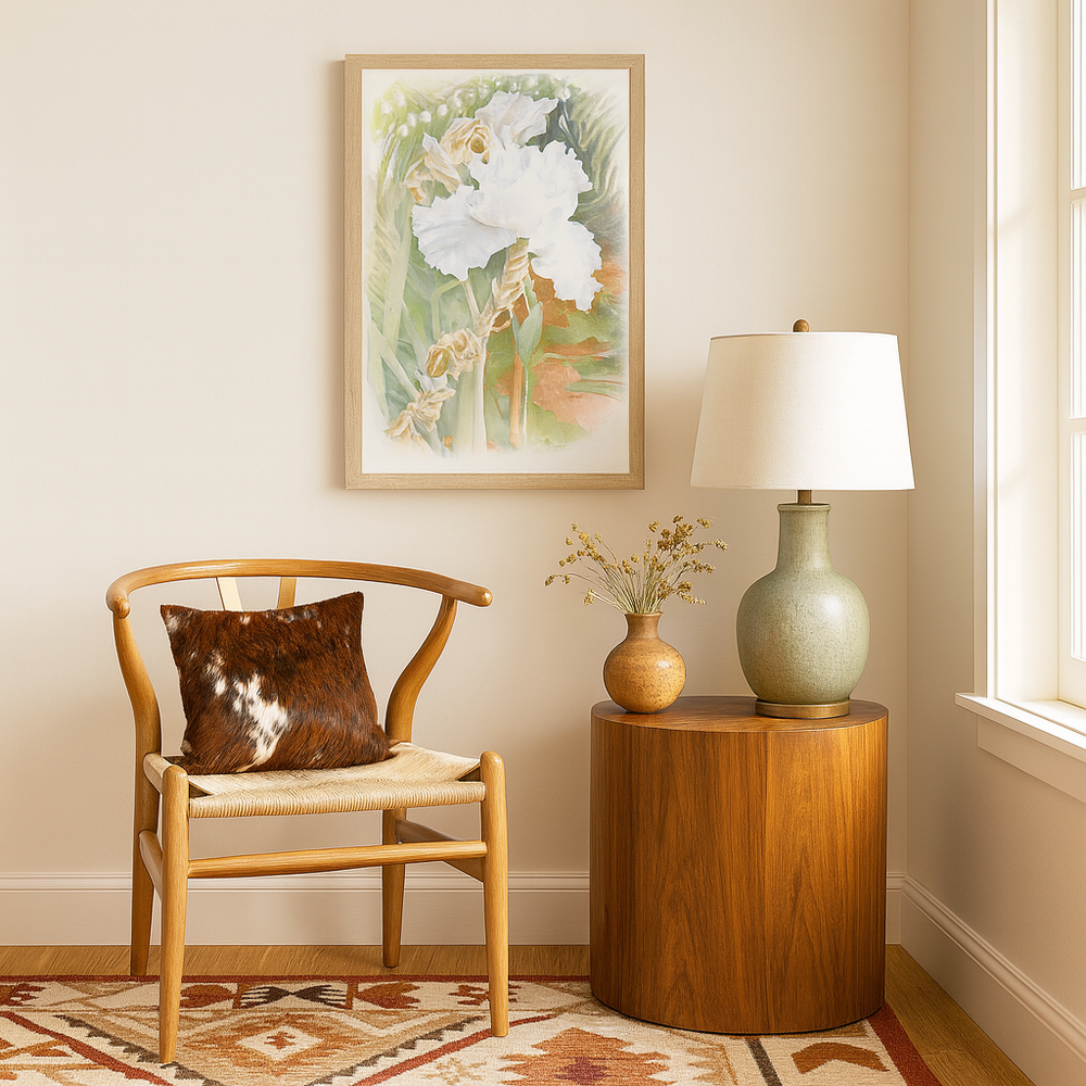 Southwestern living room setup with wishbone chair, round table, lamp, and framed flower painting