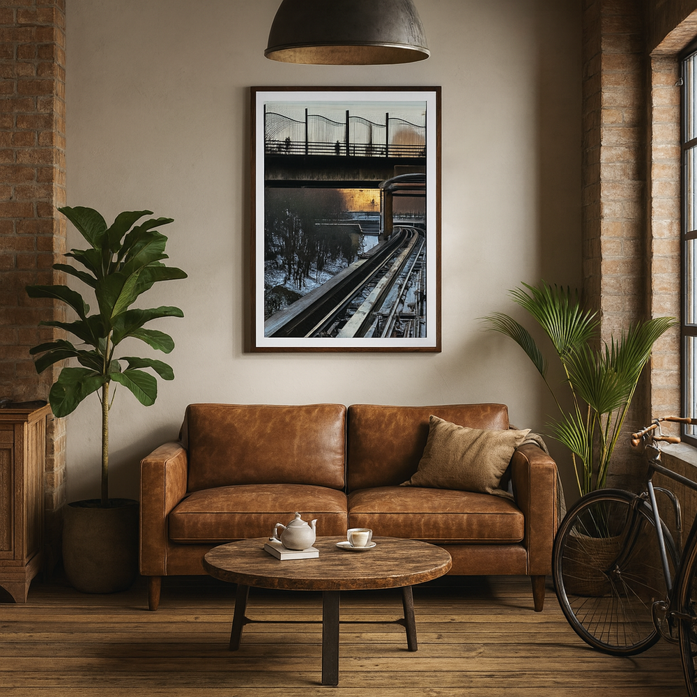 Cozy living room with brown leather sofa, wooden coffee table, and framed urbanscape picture on wall - by Andrew Semple on Bromont Media