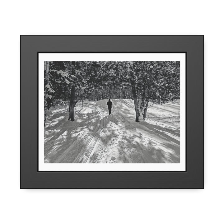 Framed winter golf art print “Winter Walk on the Golf” — lone figure on snowy fairway between frosted trees, Bromont Quebec.
