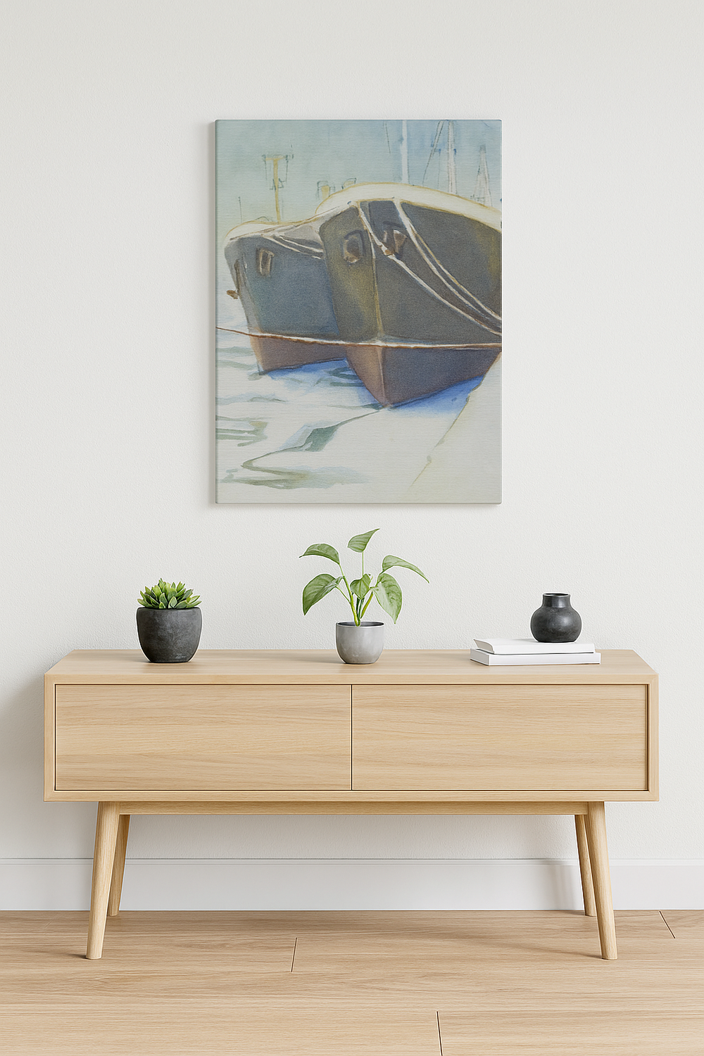 Wooden console table with decorative items against a white wall with a painting of a boat.
