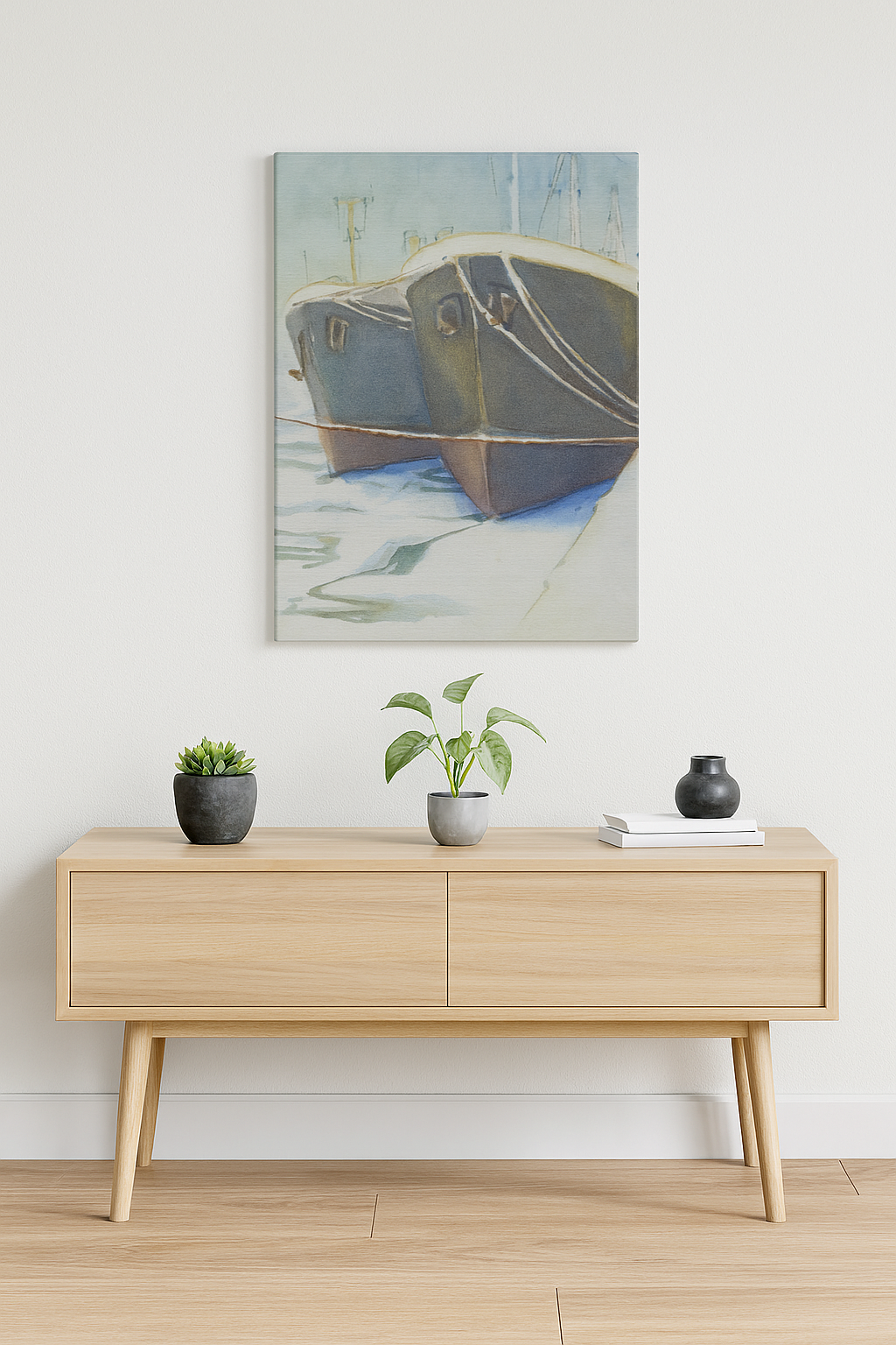 Wooden console table with decorative items against a white wall with a painting of a boat.