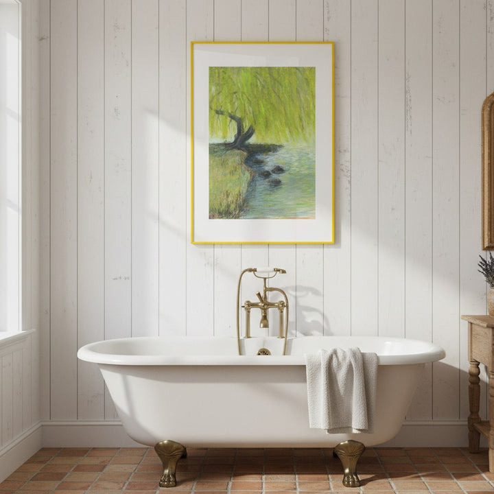 Bathroom with a freestanding bathtub, gold faucet, and framed artwork on the wall.