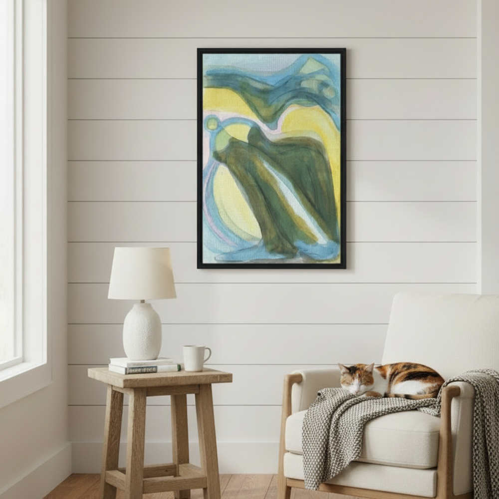 Living room with abstract art on the wall, wooden side table, and chair with a cat - Bromont Media