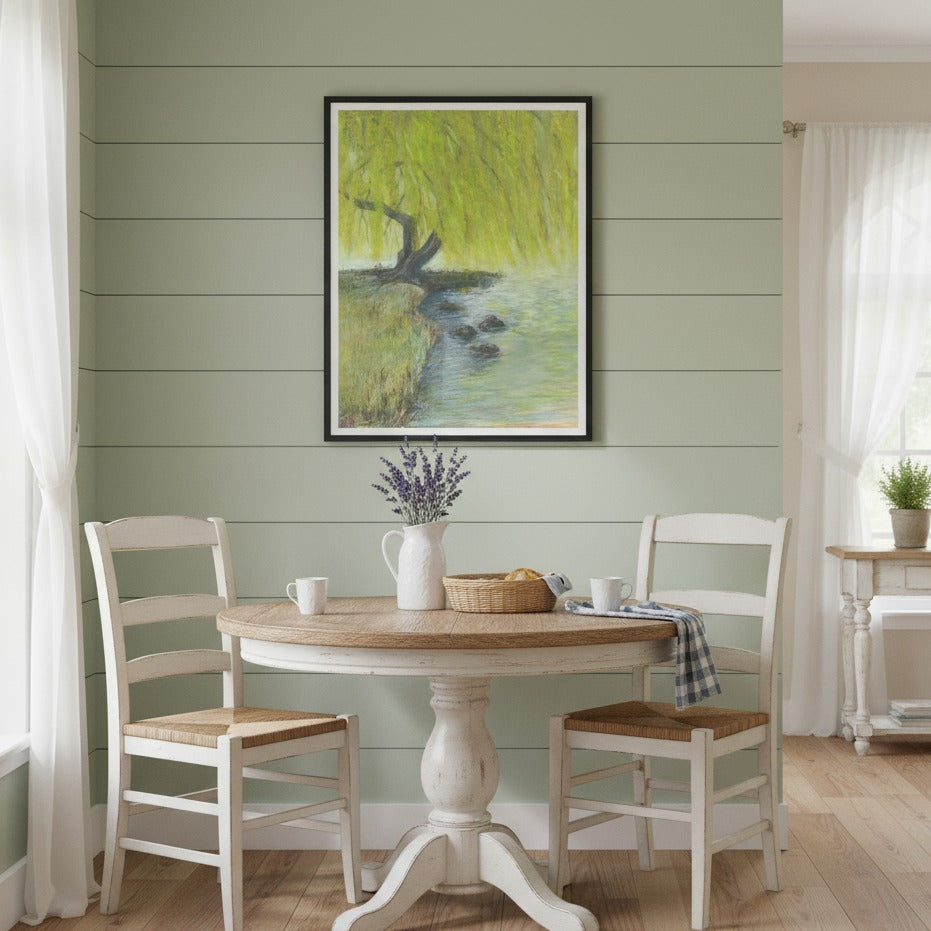 Dining room with a round wooden table and white chairs, featuring a painting on the wall - Bromont Media