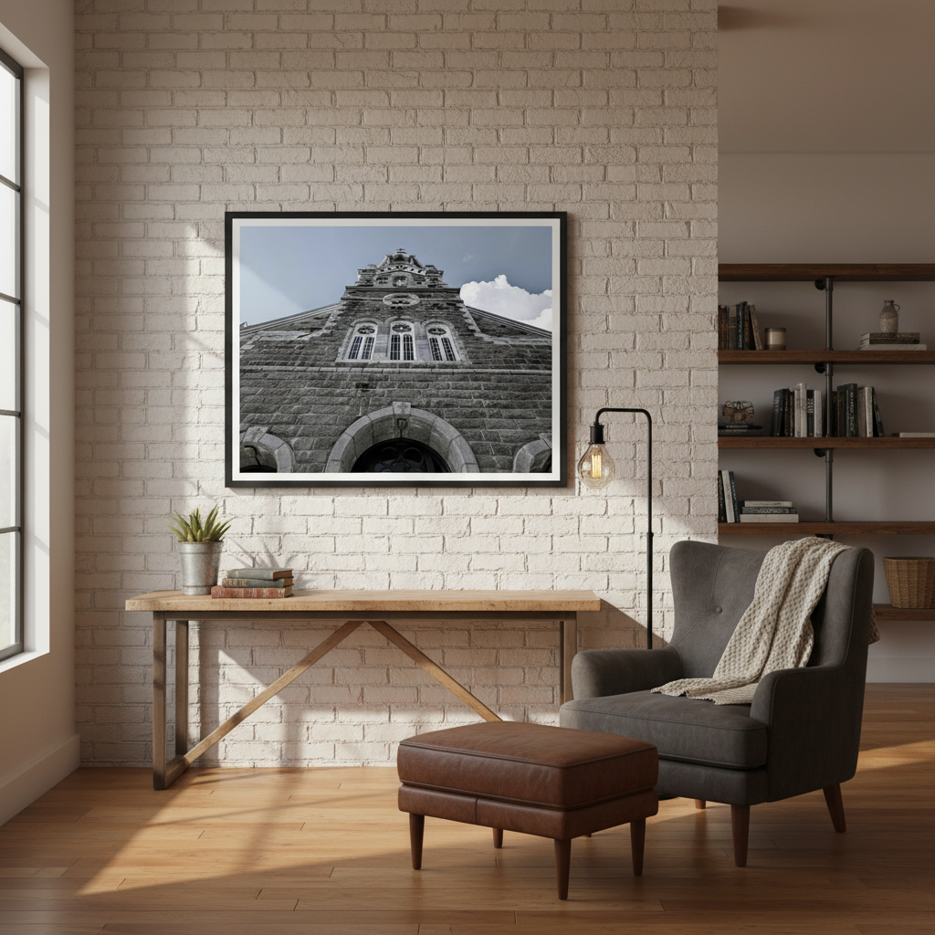 Modern interior with a brick wall, wooden desk, armchair, and framed architectural picture by Studio Shefford