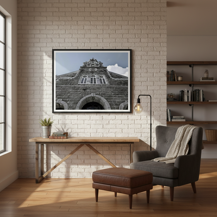Modern interior with a brick wall, wooden desk, armchair, and framed architectural picture by Studio Shefford