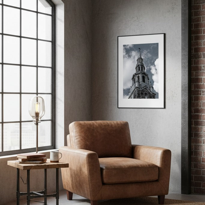 Brown armchair in a room with a large window, side table, and framed picture on the wall - Bromont Media