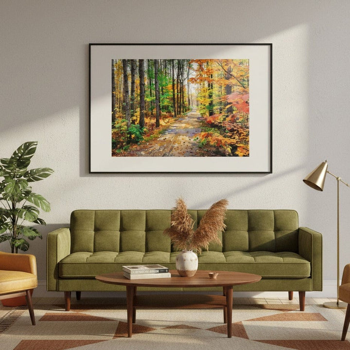 Living room with a green sofa, coffee table, and framed forest painting on the wall.