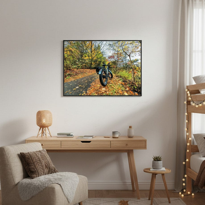 Framed artwork of a fat bike on a forest path in a bedroom setting.