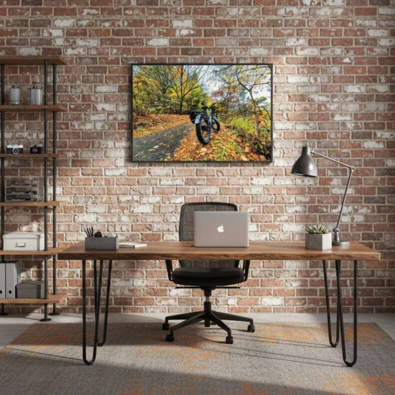 Modern office setup with a desk, chair, and wall art depicting a scenic bike path - Studio Shefford