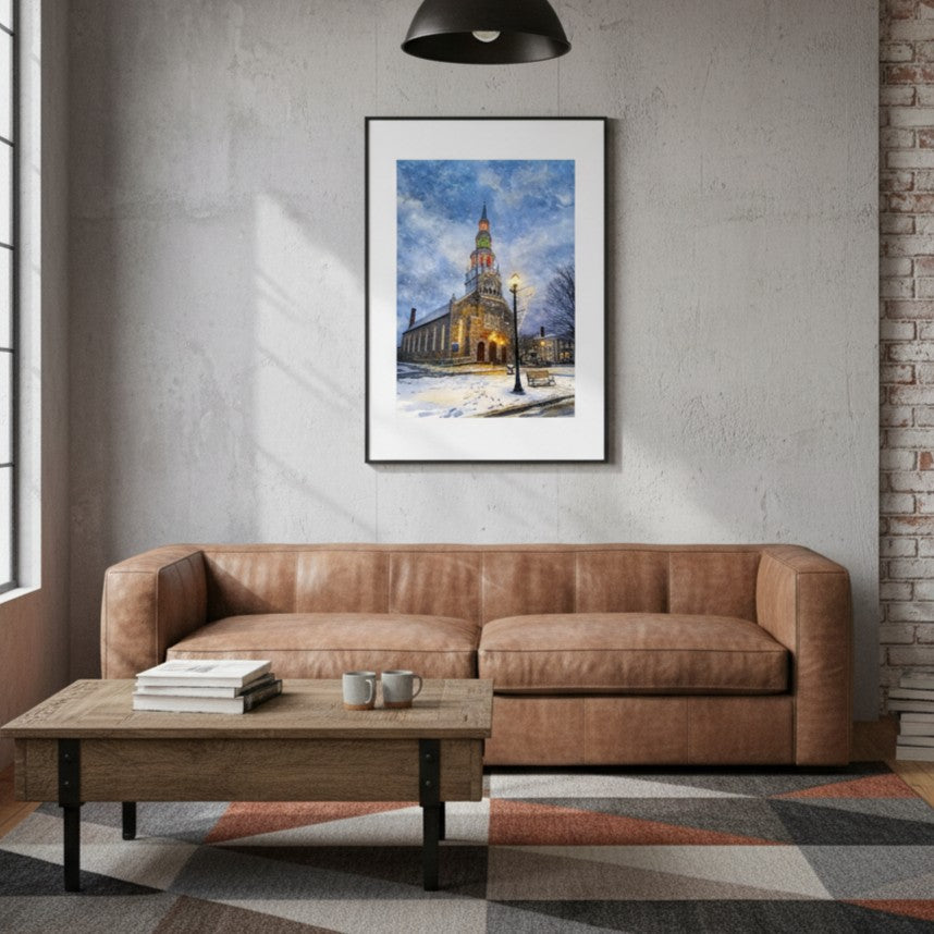 Living room with brown leather sofa, wooden coffee table, and framed picture of a snowy church.