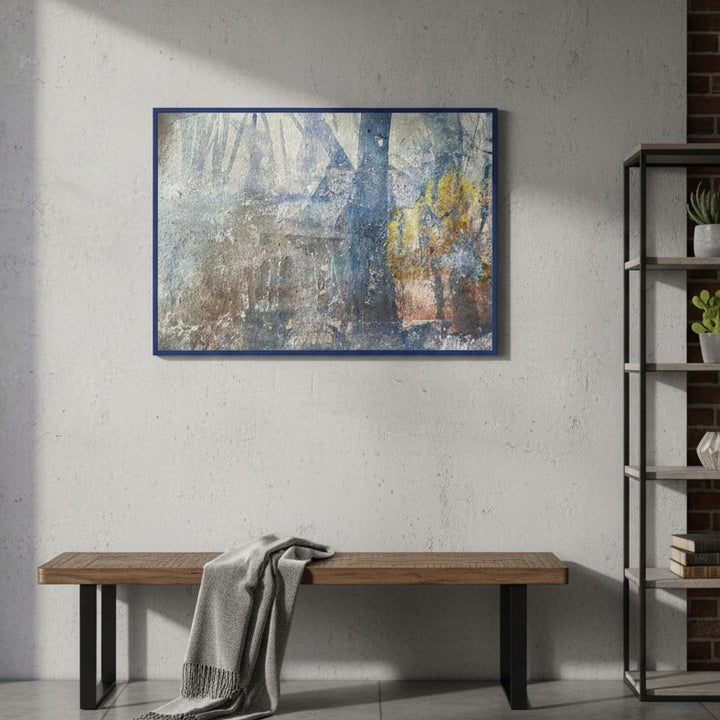 Abstract painting on a wall above a wooden bench in a room with a bookshelf.