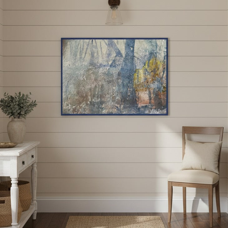 Room interior with a painting on the wall, a chair, and a small table.