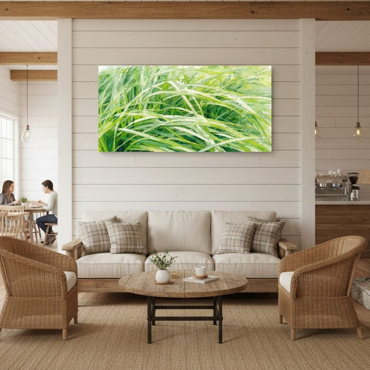Living room with a large green abstract nature painting on the wall, beige sofa, and wicker chairs.