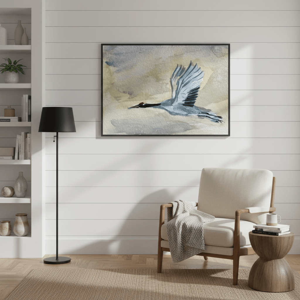 Living room with a beige armchair, wooden side table, and framed artwork on the wall - Bromont Media