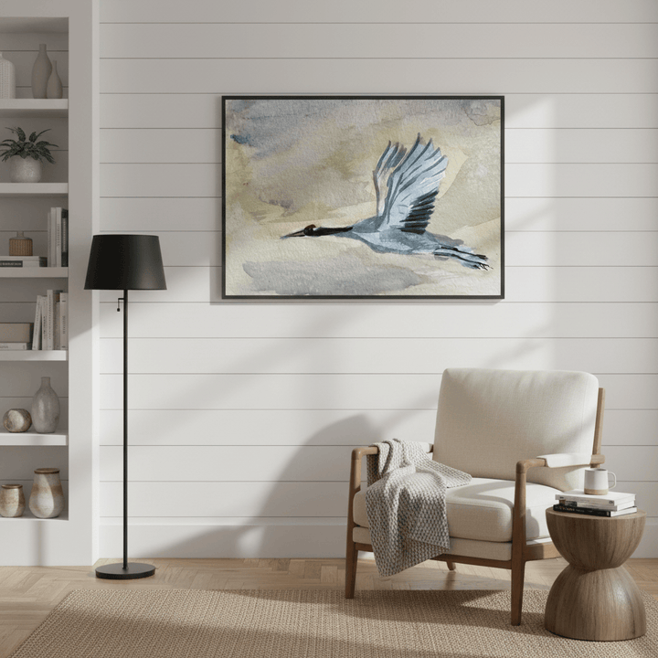 Living room with a beige armchair, wooden side table, and framed artwork on the wall - Bromont Media