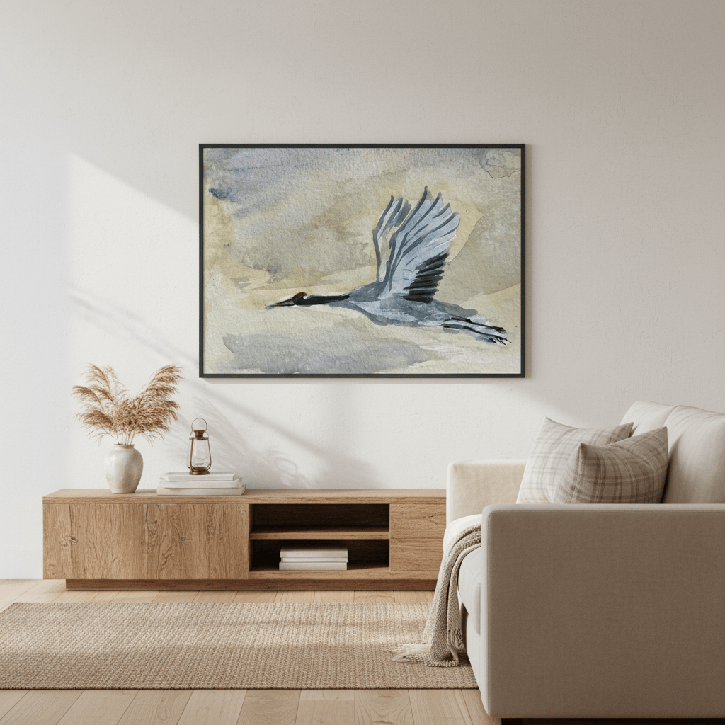 Living room with a framed artwork of a Blue Heron, wooden cabinet, and beige sofa - Bromont Media