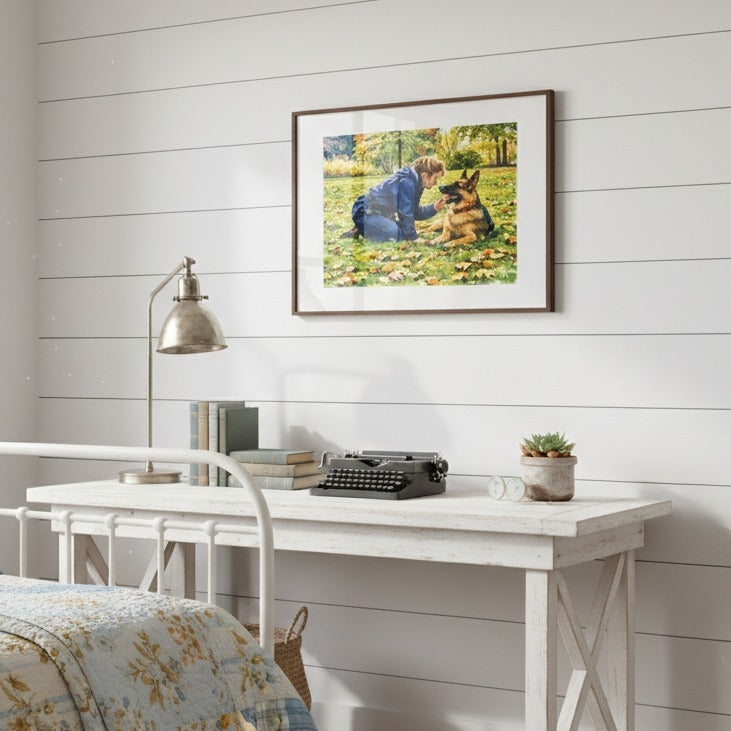 Framed artwork of a woman and a dog on a wall above a desk with a lamp and books - Studio Shefford