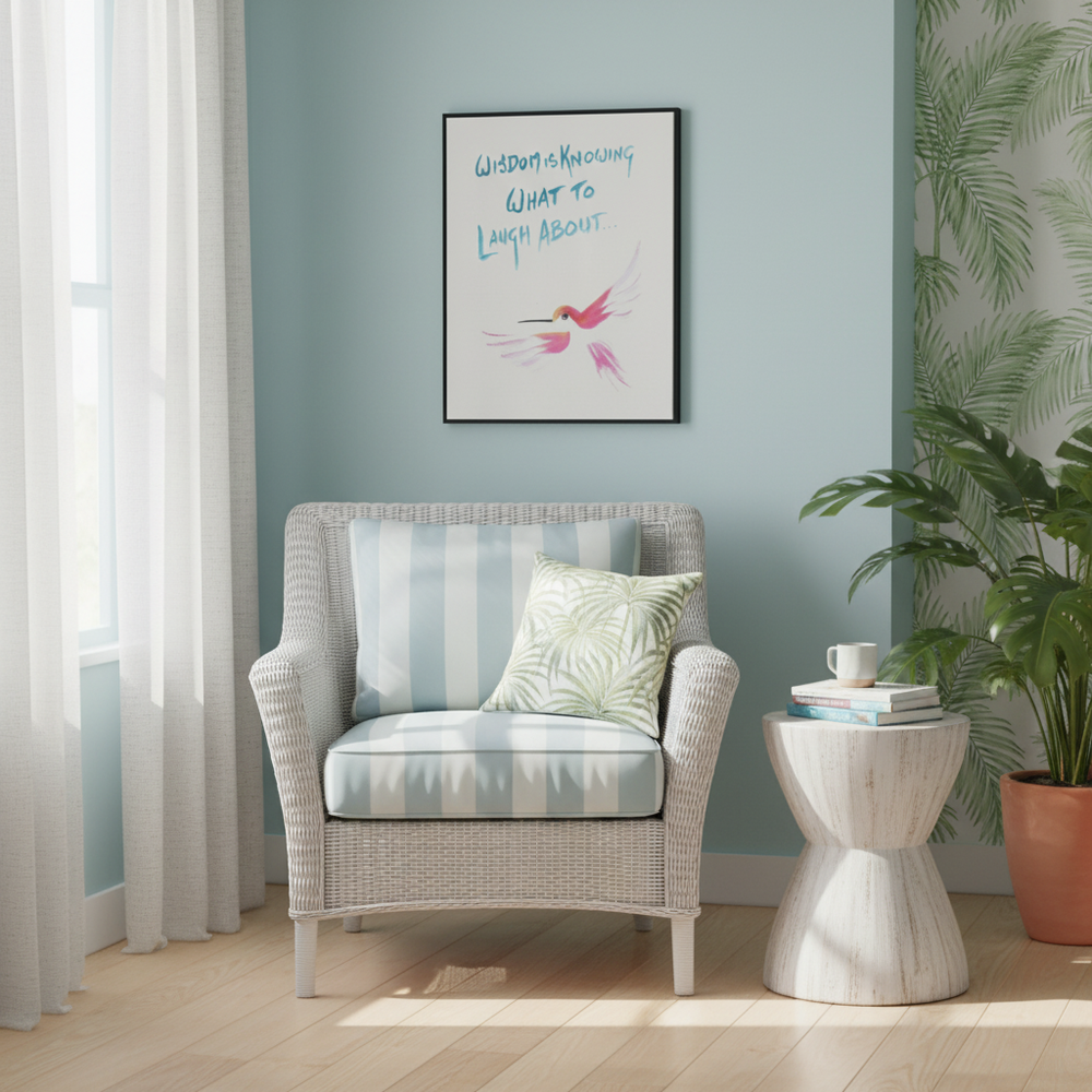 Cozy reading nook with a wicker armchair, cushions, a side table, and a framed painting of a hummingbird with a quote on the wall - by Andrew Semple on Bromont Media
