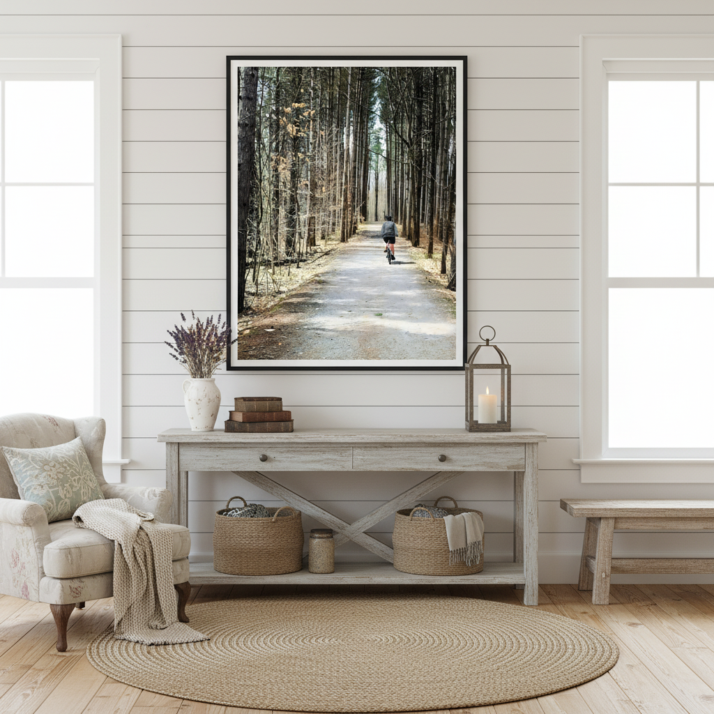 Living room with a forest-themed framed picture on the wall, a console table with decor items, and a chair - Studio Shefford