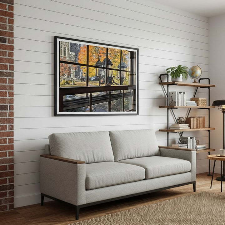 Gray sofa in a living room with a wall photocomposition by Studio Shefford and shelves.