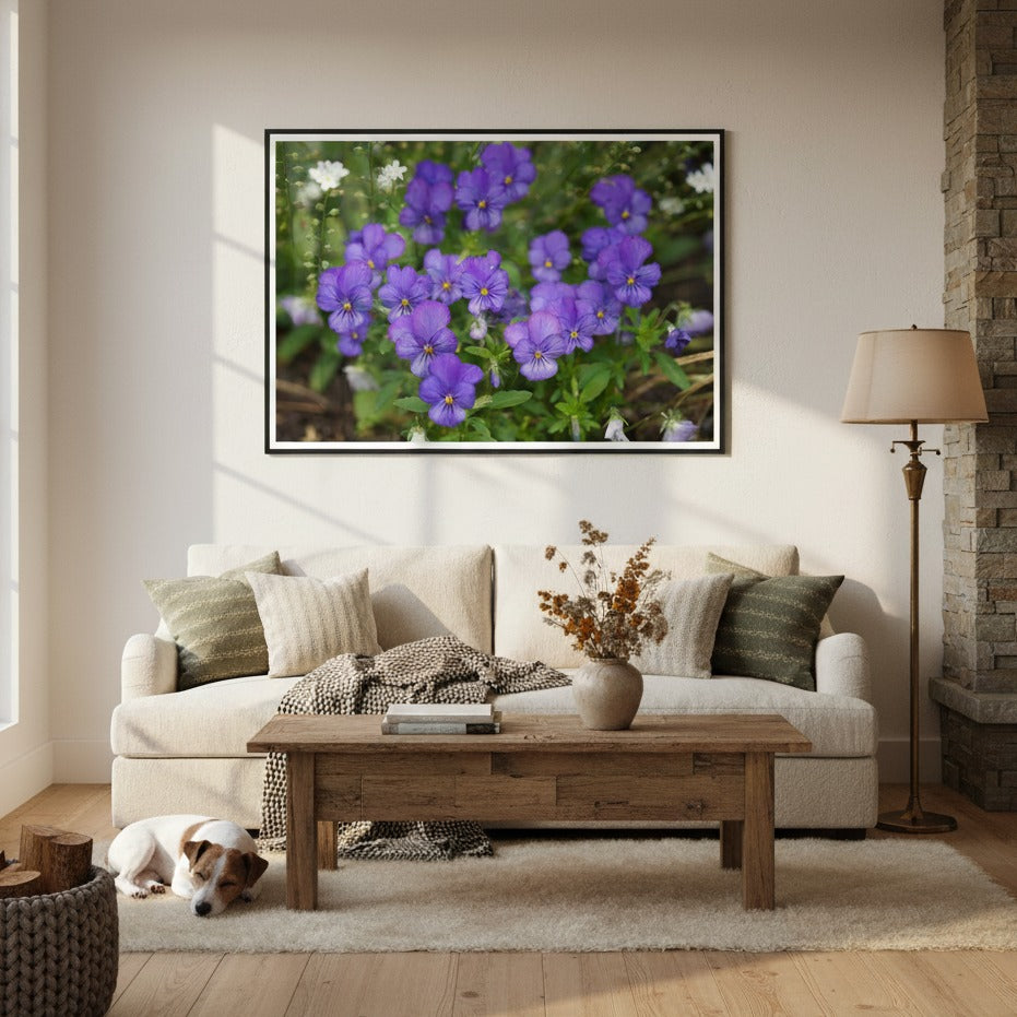 Living room with a couch, coffee table, and framed art by Andrew Semple of purple flowers on the wall - Bromont Media