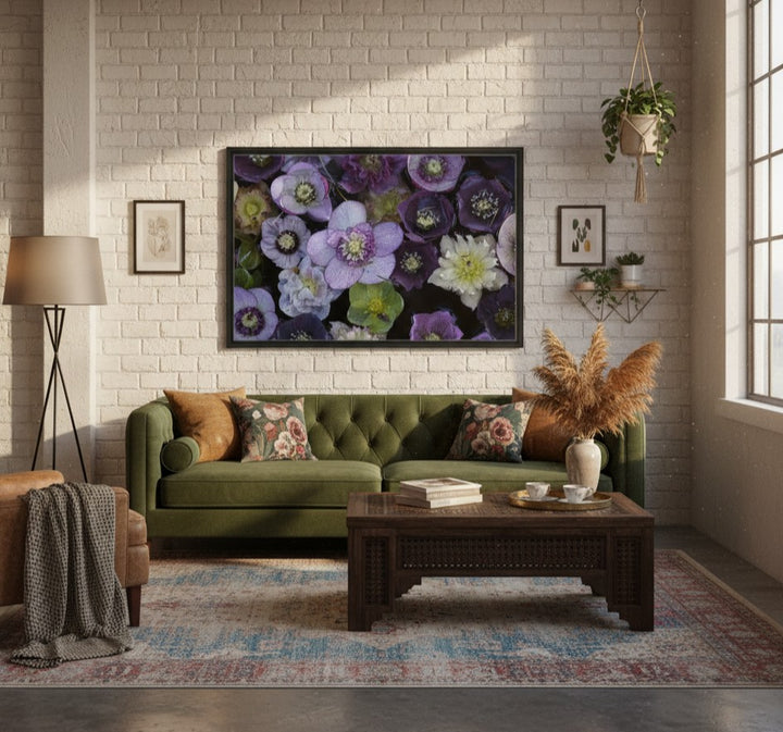 Living room with a green sofa, coffee table, and floral artwork on a brick wall by Andrew Semple