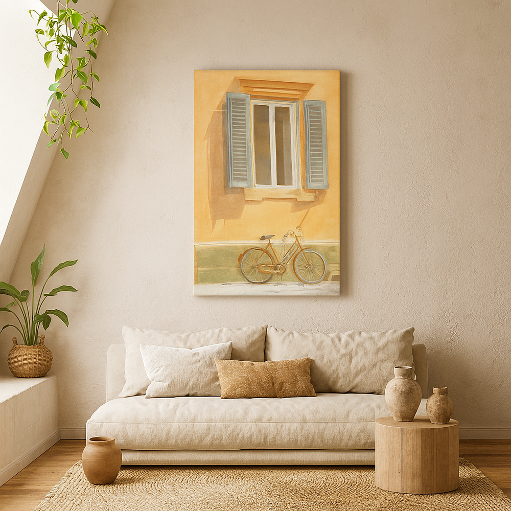 Living room with a beige sofa, decorative pillows, and a wall painting of a bicycle by a window.