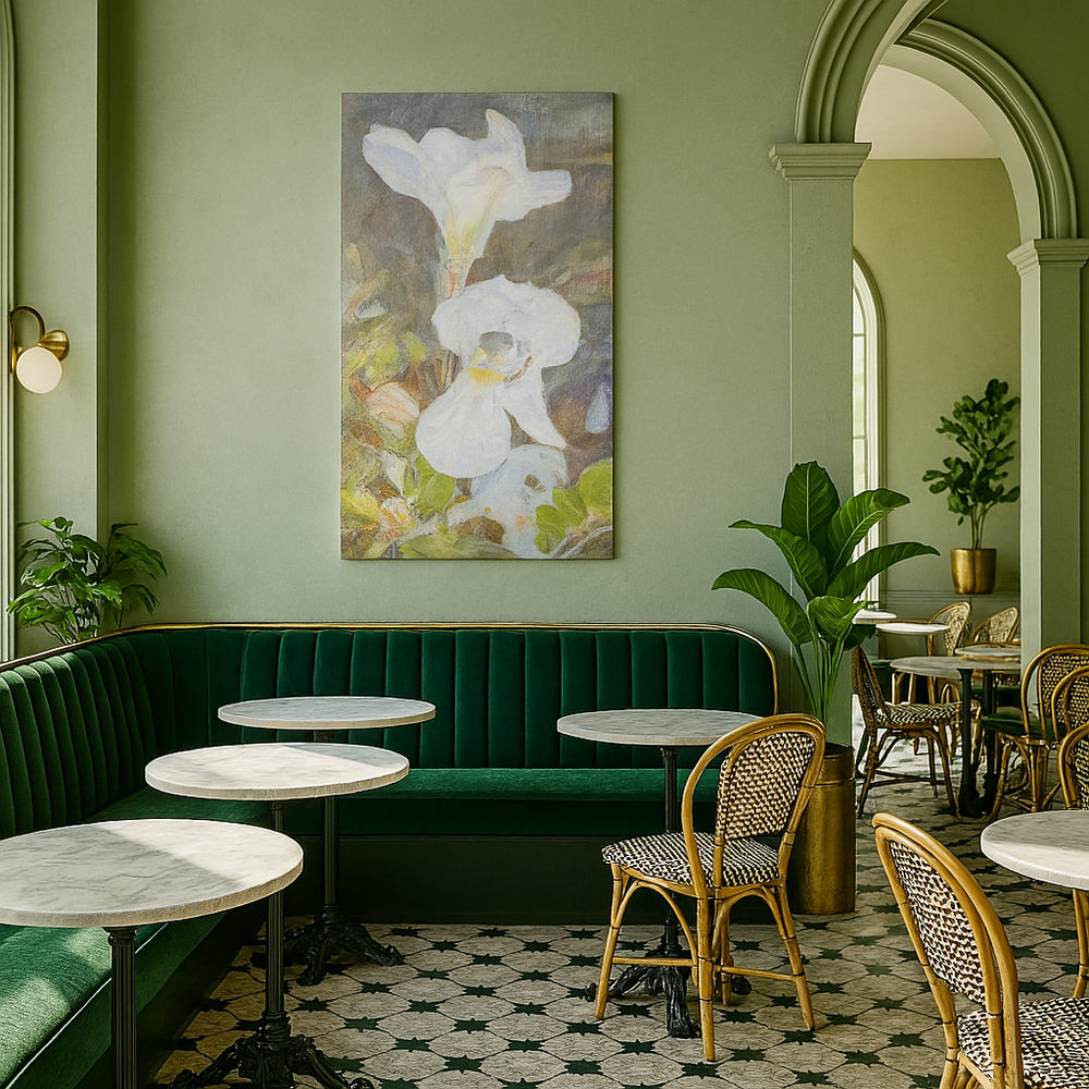 Green interior with a floral painting, green sofa, and wicker chairs.