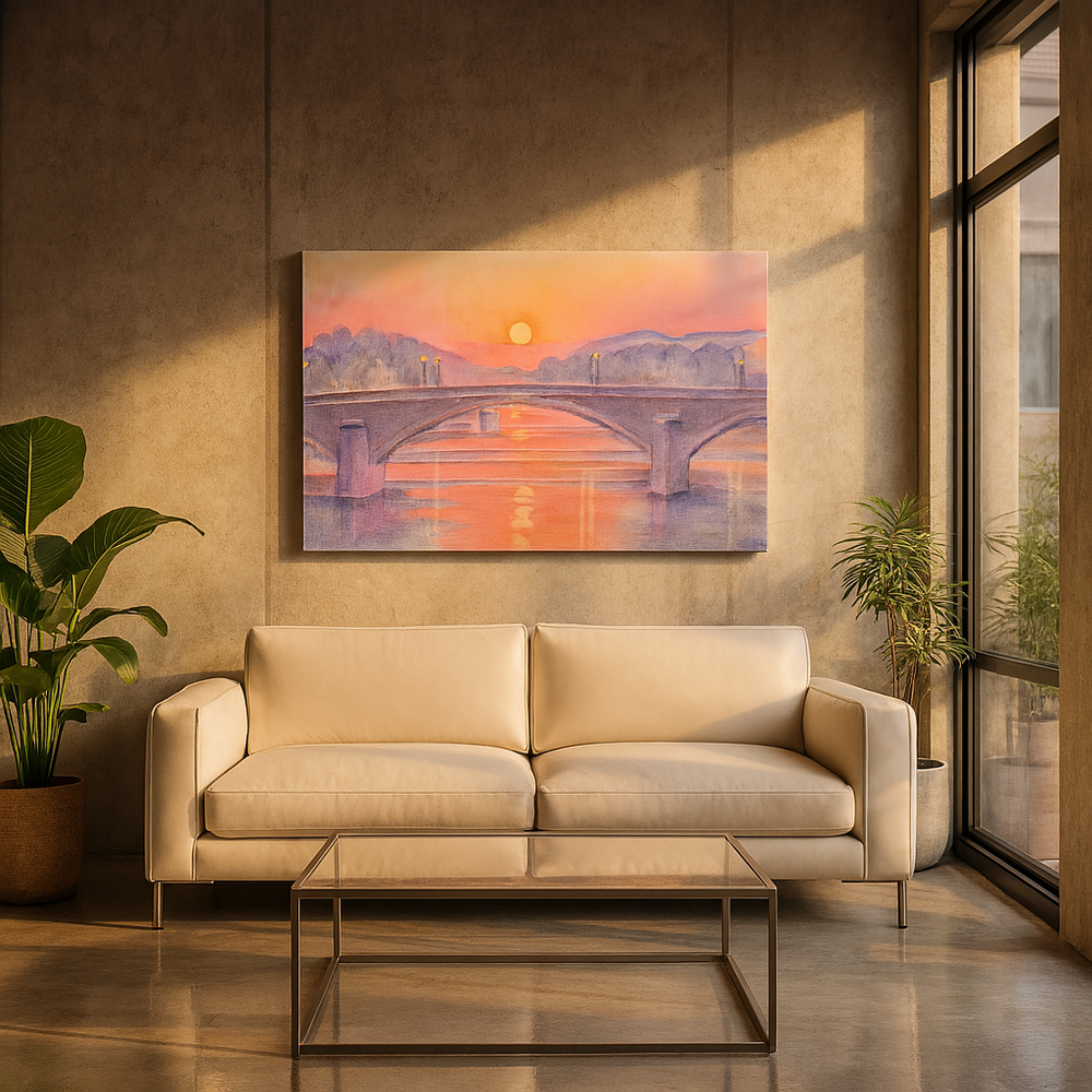 Beige sofa in a living room with a painting of a bridge over water during golden hour on the wall.