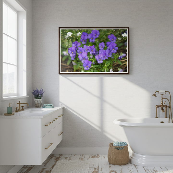 Bathroom with a framed picture of purple flowers on the wall from Bromont Media